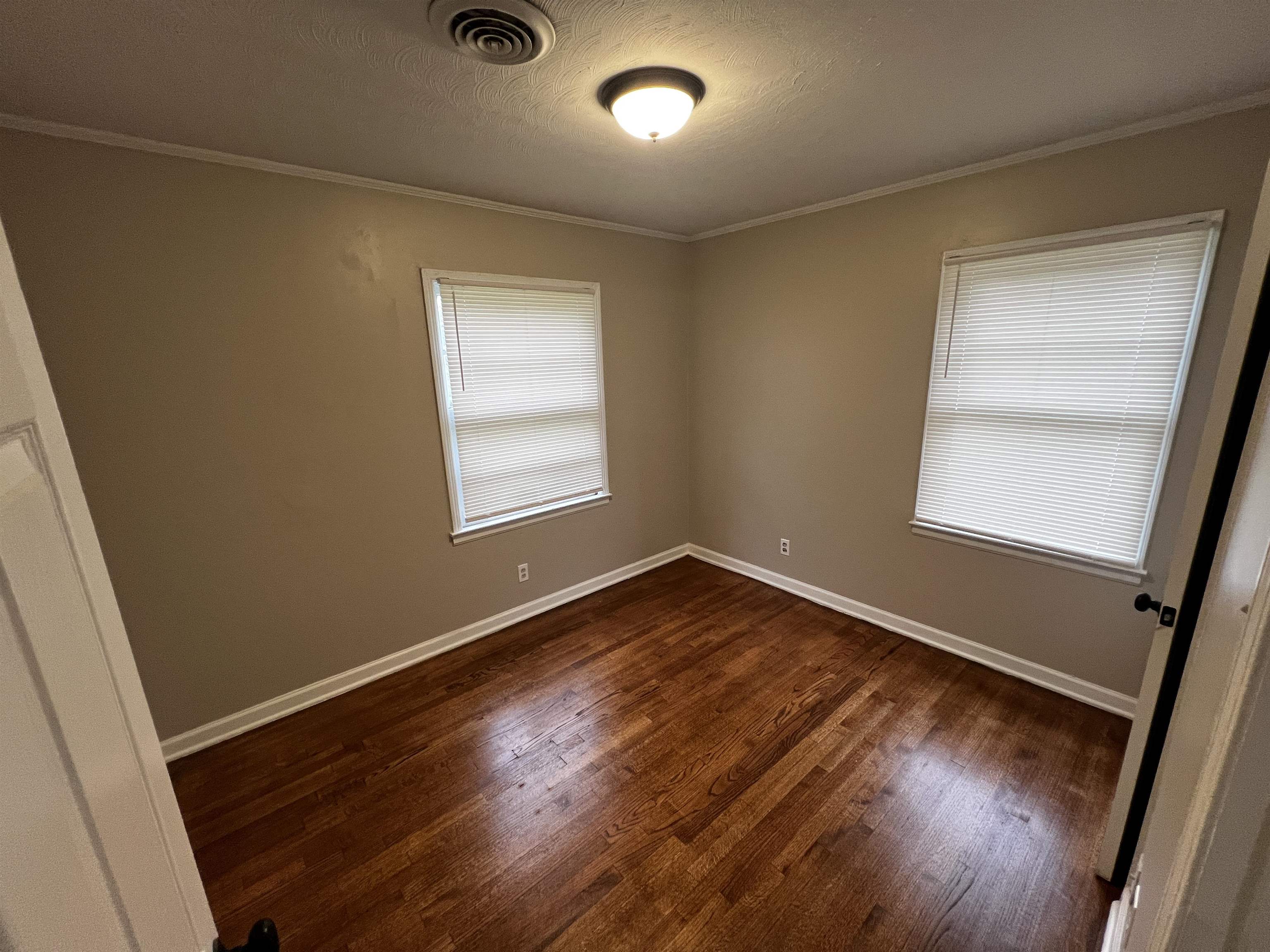 4801 Given Avenue Memphis, TN 38122 - Photo 7 of 13 an empty room with wooden floor and windows