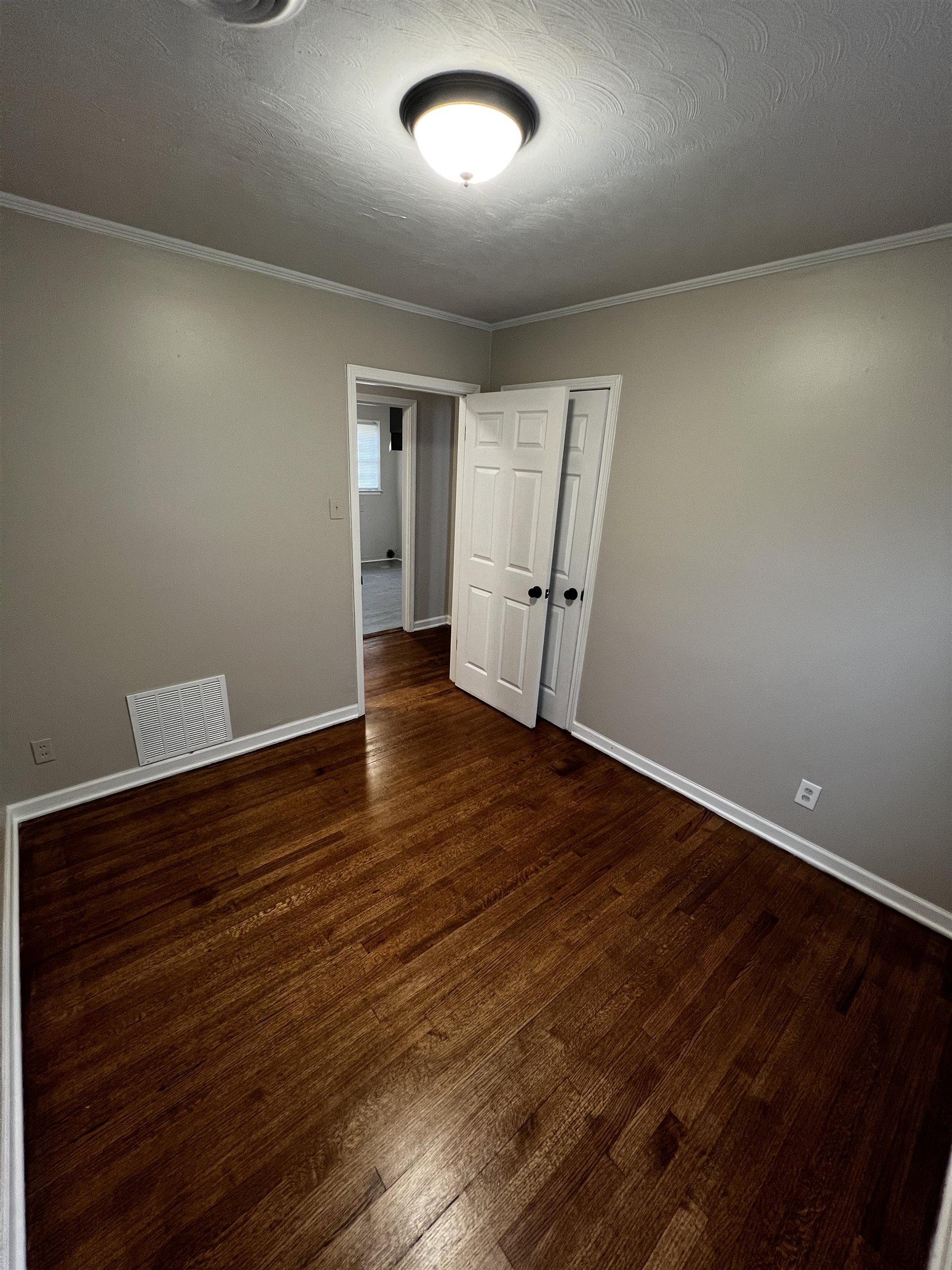 4801 Given Avenue Memphis, TN 38122 - Photo 9 of 13 an empty room with wooden floor and windows