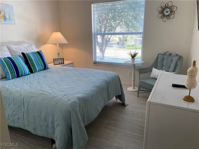 a bed sitting in a bedroom next to a window