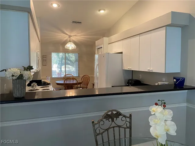 a kitchen with cabinets and window