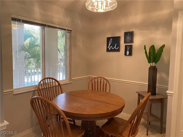 a view of a dining room with furniture window and outside view