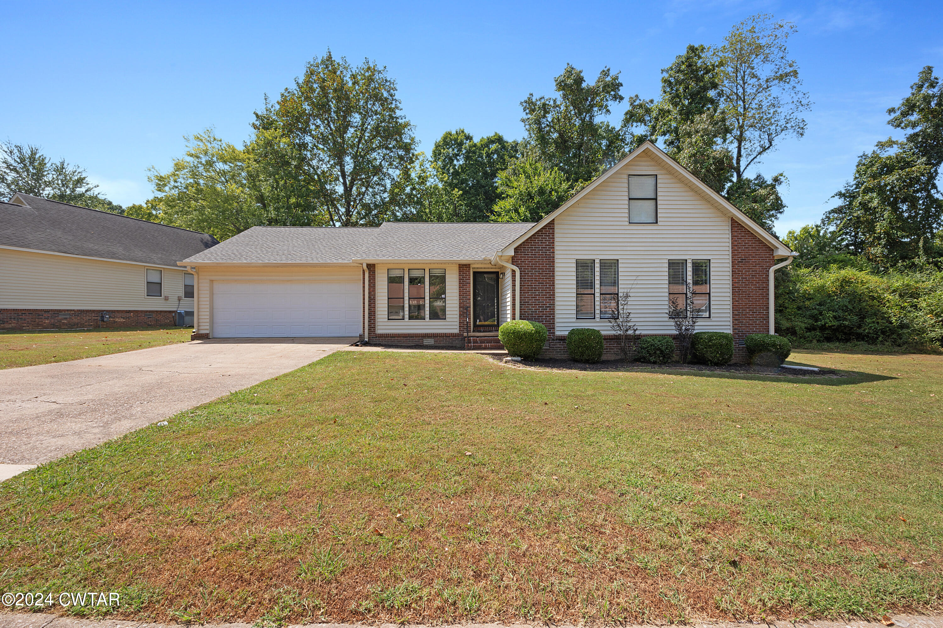117 Ridgeoak Place Jackson, TN 38305 - Photo 1 of 20 a front view of a house with a yard and trees
