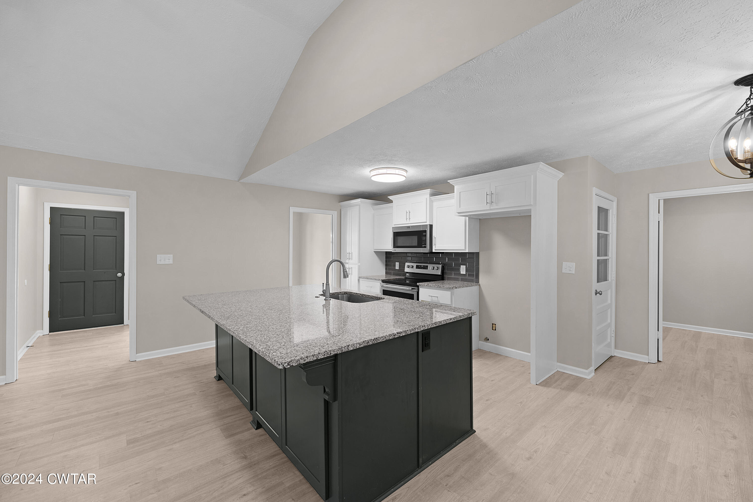 117 Ridgeoak Place Jackson, TN 38305 - Photo 7 of 20 a kitchen with kitchen island a sink stainless steel appliances and cabinets