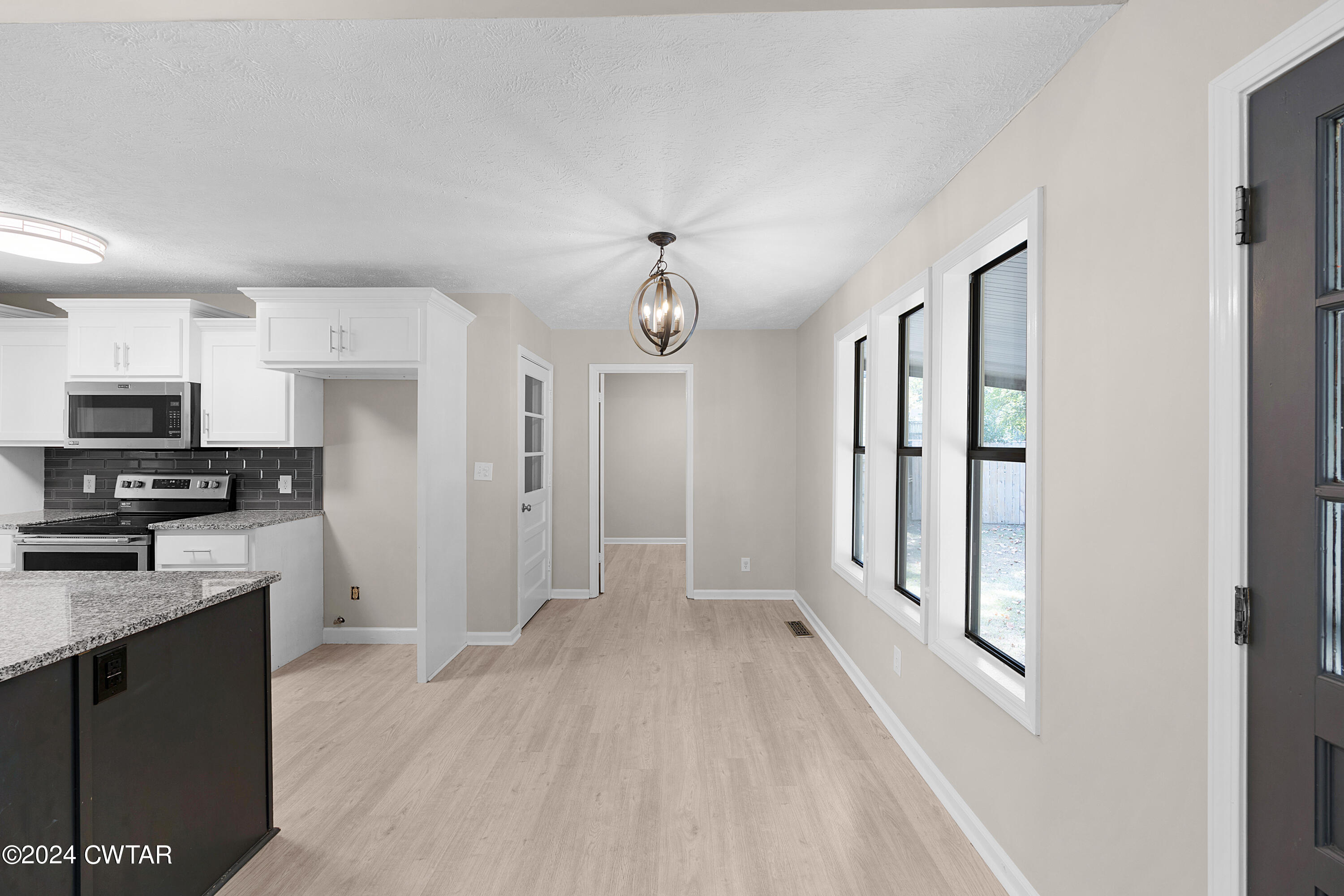 117 Ridgeoak Place Jackson, TN 38305 - Photo 8 of 20 a view of a kitchen with a sink wooden floor and cabinets