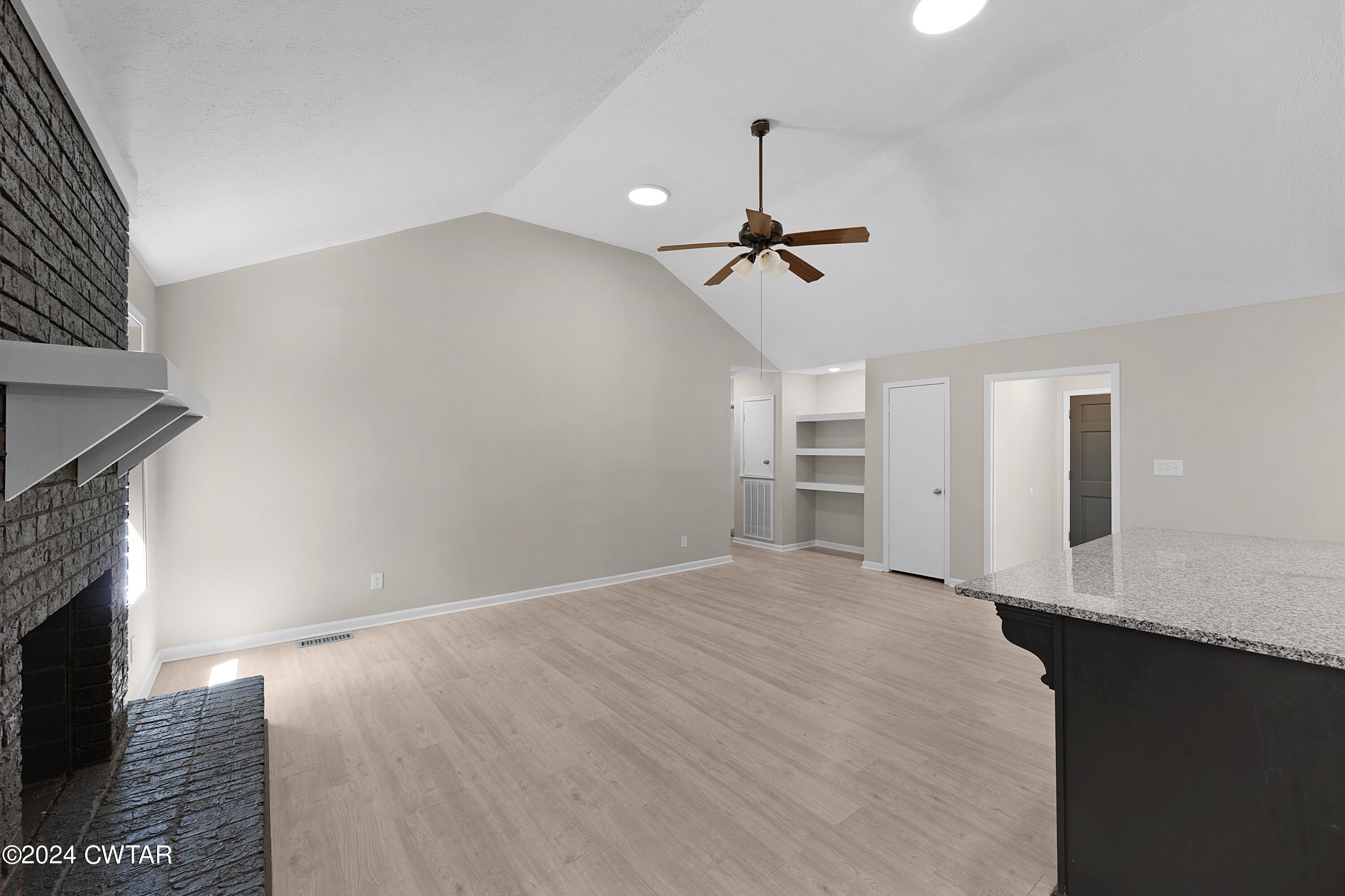 117 Ridgeoak Place Jackson, TN 38305 - Photo 9 of 20 a view of an empty room with a fireplace and a window