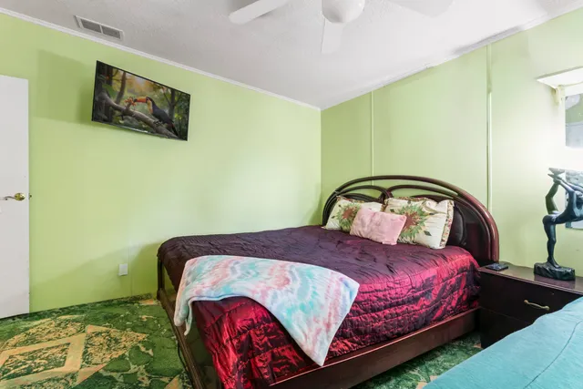 a bedroom with a bed and wall painting