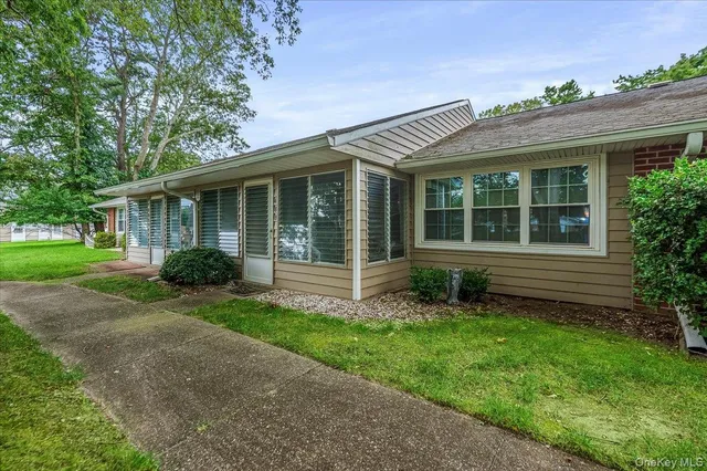 a view of a house with a yard and plants
