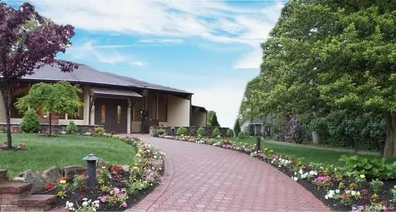 a front view of a house with a garden and porch