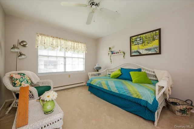 a bedroom with a bed mirror and a window