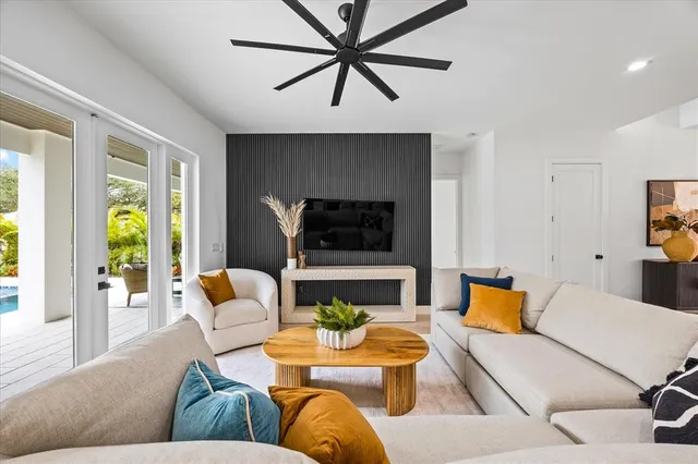 a kitchen with stainless steel appliances granite countertop a sink a stove and a wooden floors