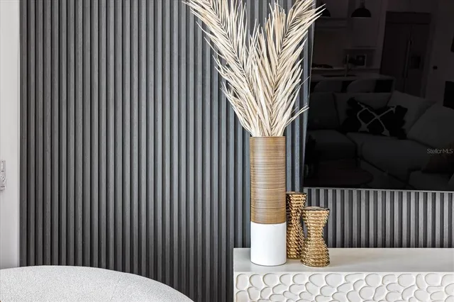 a view of a room with wooden floor and a ceiling fan