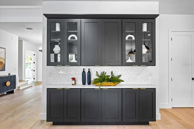 a spacious bathroom with a granite countertop sink mirror and a bathtub