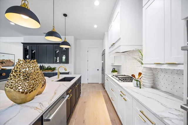 a bathroom with a double vanity sink toilet mirror and shower