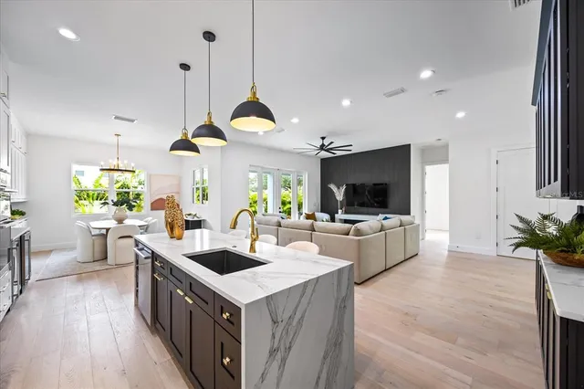 a view of a house with backyard and sitting area