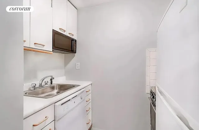 a kitchen with a sink and microwave