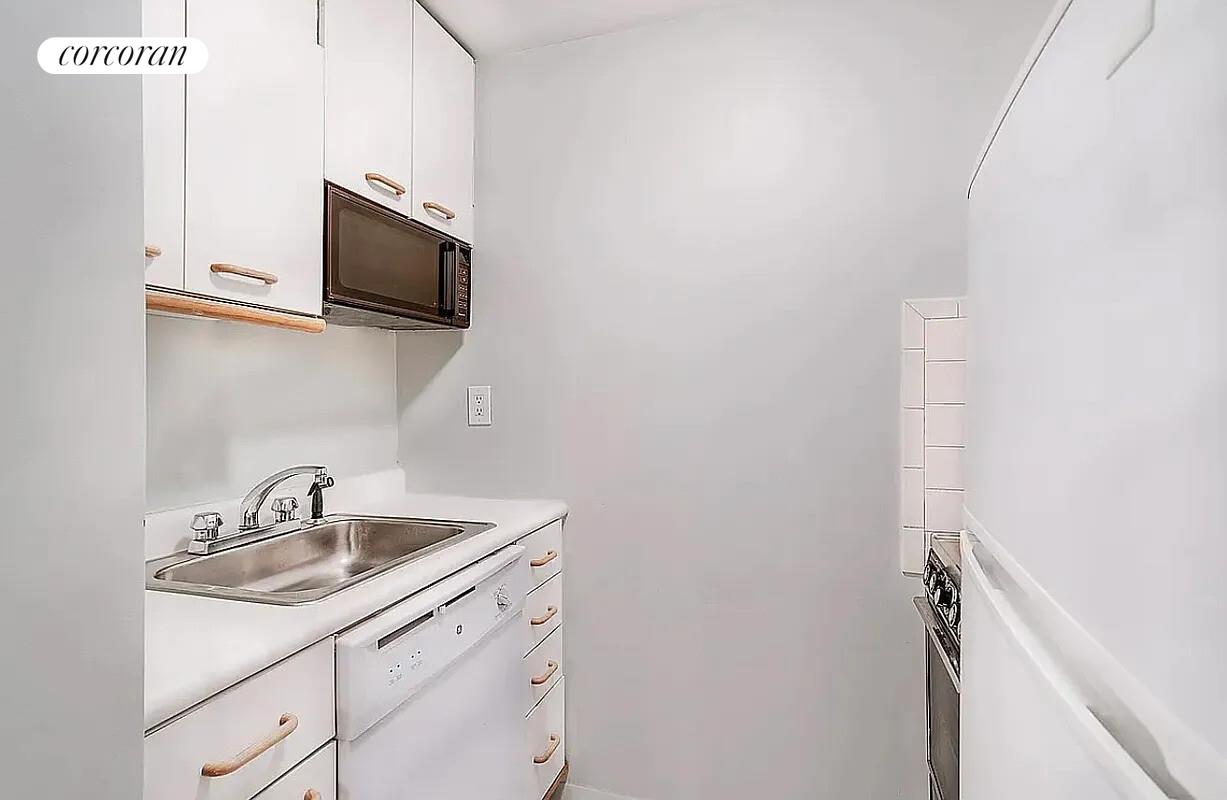 350 West 50th Street, Unit 4BB Manhattan, NY 10019 - Photo 3 of 14 a kitchen with a sink and microwave
