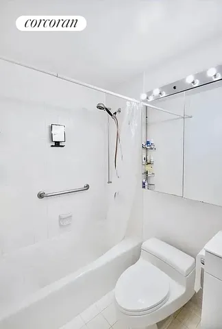 a bathroom with a toilet and a bath tub