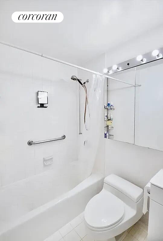 350 West 50th Street, Unit 4BB Manhattan, NY 10019 - Photo 4 of 14 a bathroom with a toilet and a bath tub