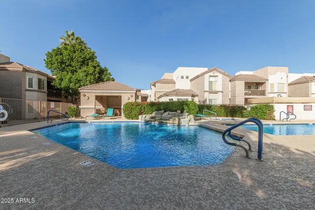a view of a house with swimming pool and sitting area