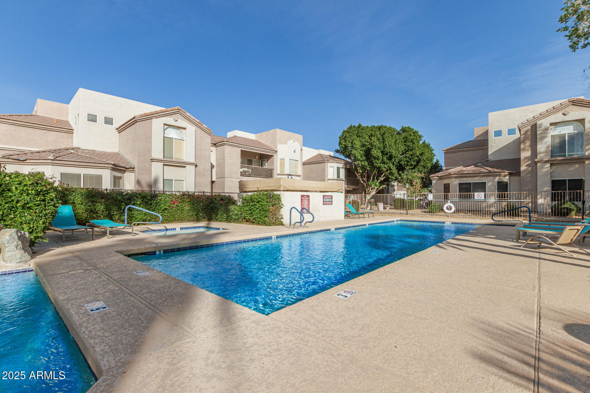 17017 North 12th Street, Unit 1035 Phoenix, AZ 85022 - Photo 14 of 19 a view of a house with pool and chairs