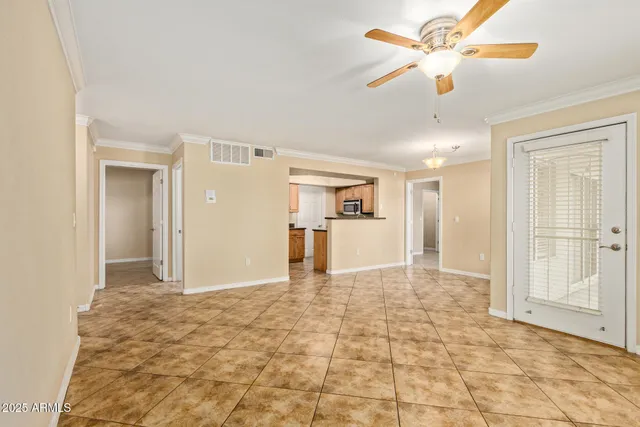 a view of a big room with wooden floor and a ceiling fan