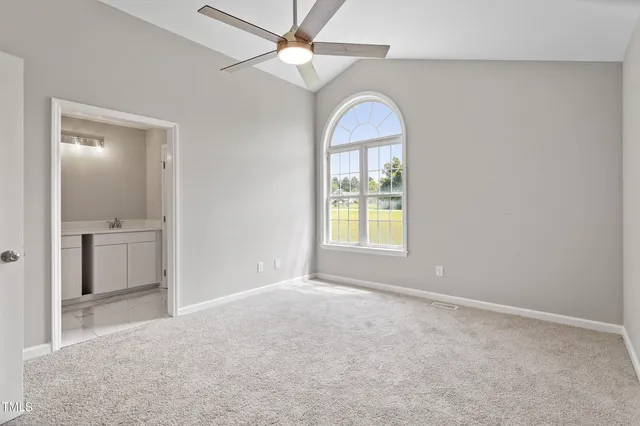 an empty room with a bathroom and a sink