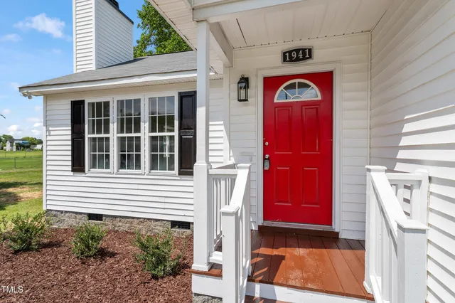 a front view of a house with a red gate