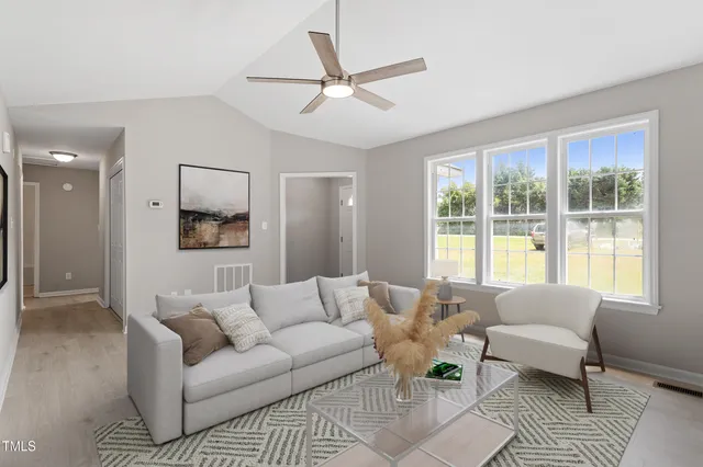 a living room with furniture and a large window