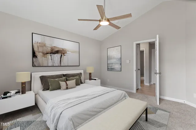 a bedroom with a large bed and a chandelier