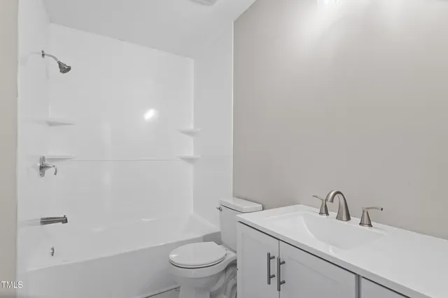 a bathroom with a sink toilet and vanity