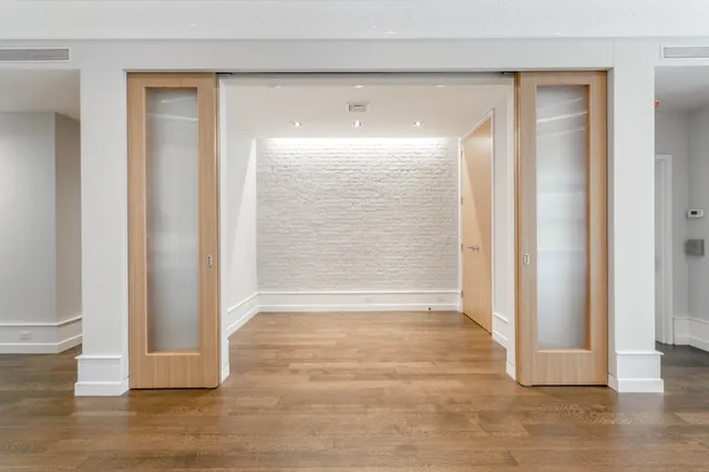 a view of wooden floor and brick walls