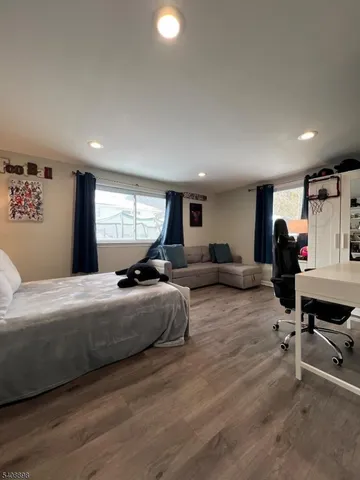 a bedroom with furniture and a large window