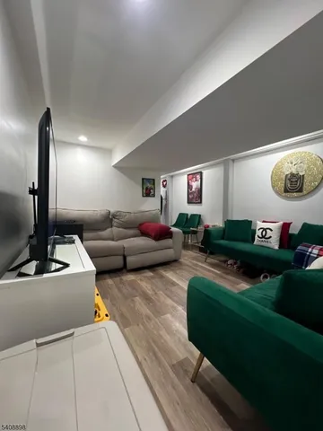 a living room with furniture and a lamp