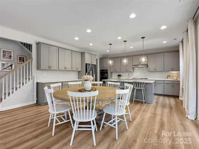 a view of kitchen with cabinets table and chairs