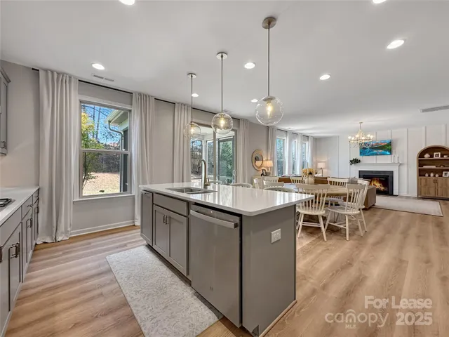 a kitchen with lots of counter top space and wooden floor