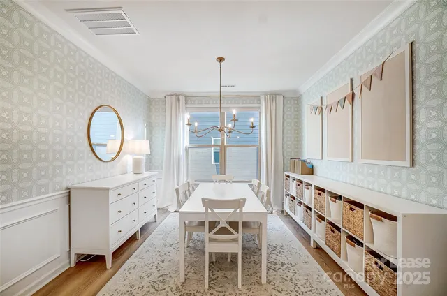 a living room with furniture a table and a chandelier
