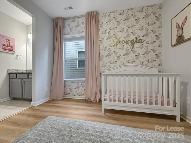 a view of a room with wooden floor and a window