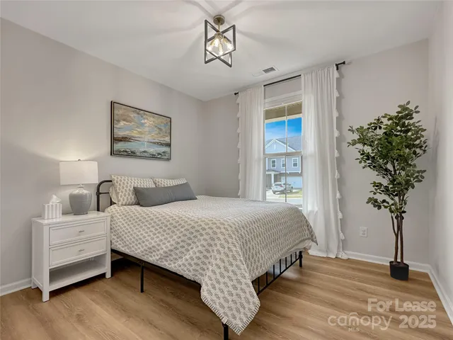 a bedroom with a large bed table and a window