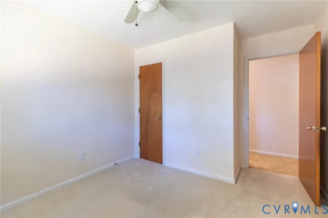 an empty room with a ceiling fan