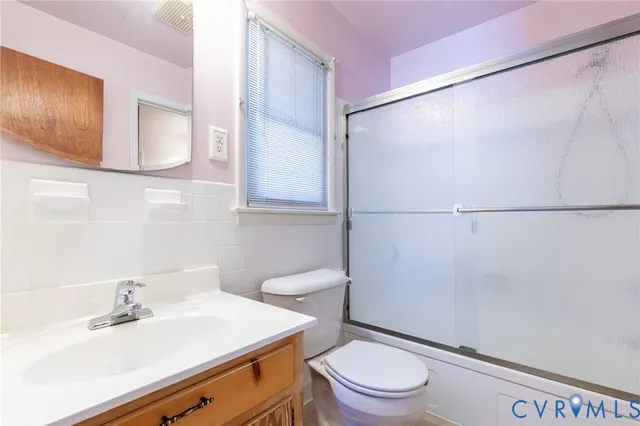 a bathroom with a sink a mirror and a toilet