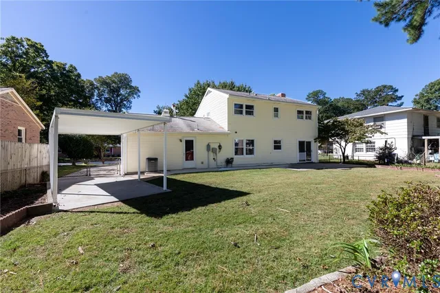 a view of a white house with a yard