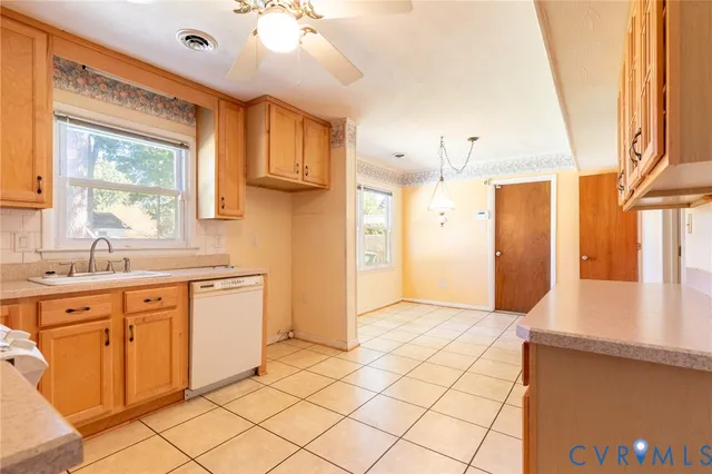 a kitchen with granite countertop a sink cabinets and stainless steel appliances