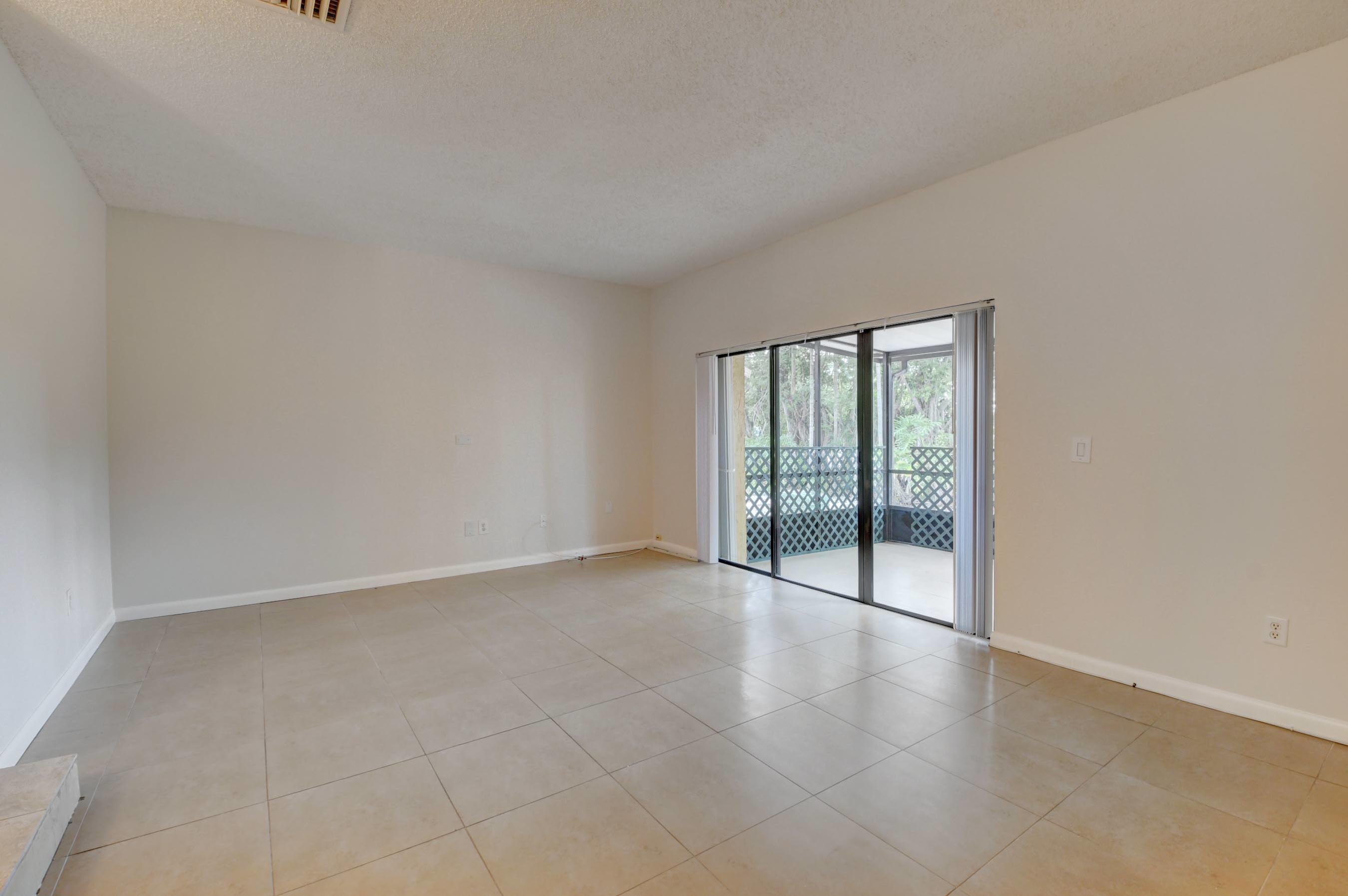 21748 Juego Circle, Unit 21E Boca Raton, FL 33433 - Photo 32 of 56 wooden floor in an empty room with a window