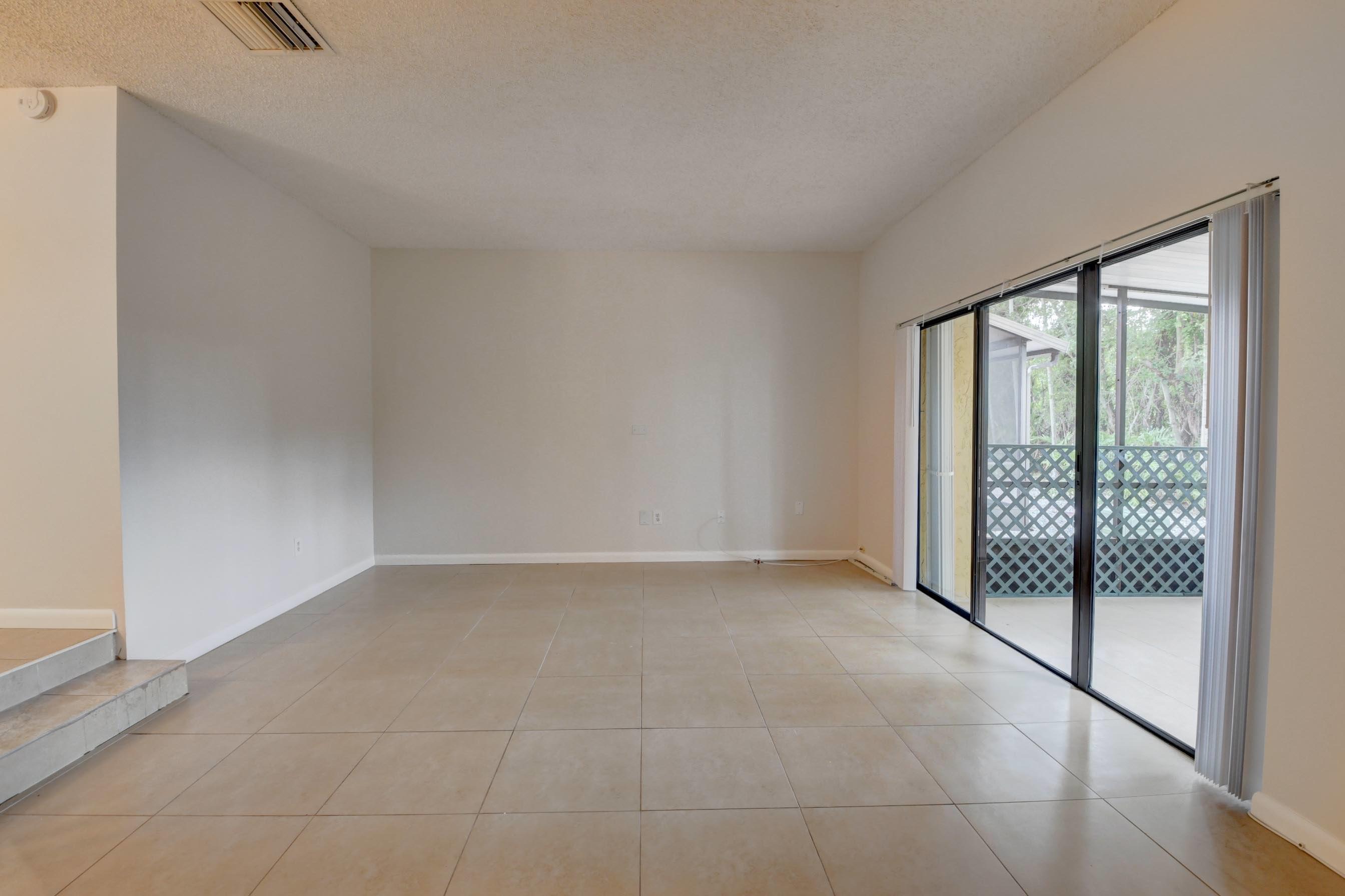 21748 Juego Circle, Unit 21E Boca Raton, FL 33433 - Photo 33 of 56 a view of an empty room with glass door