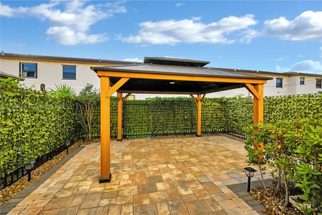 a backyard of a house with table and chairs