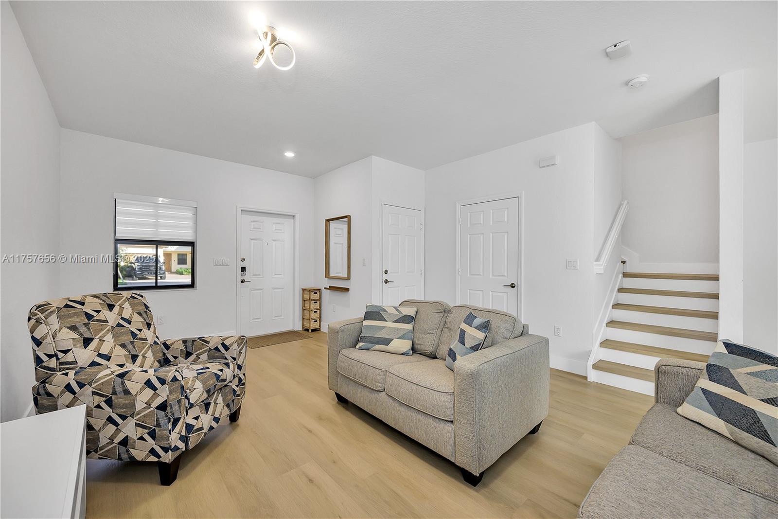 4671 Santa Cruz Way, Unit 4671 Davie, FL 33314 - Photo 5 of 20 a living room with furniture and wooden floor