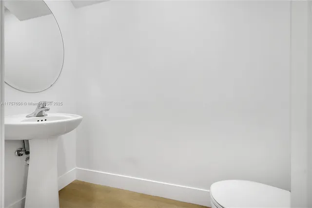 a bathroom with a sink a toilet and mirror
