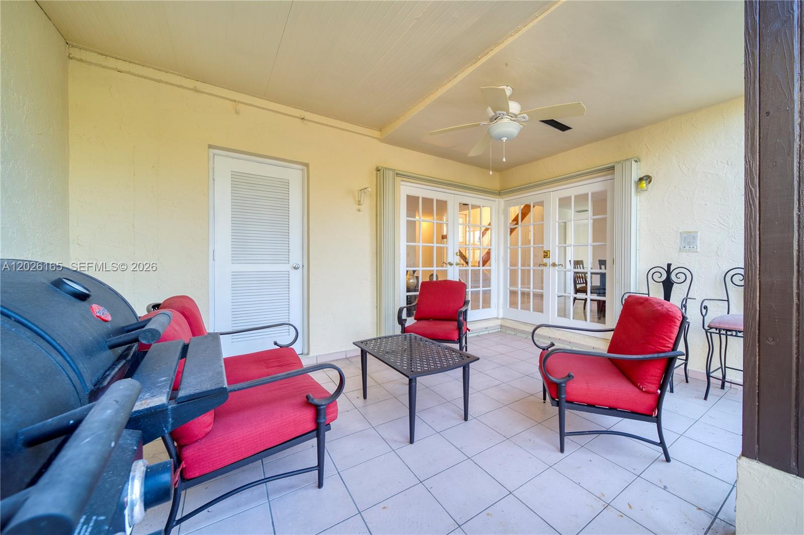 13337 Southwest 64th Lane Miami, FL 33183 - Photo 32 of 36 a living room with furniture and a red lamp