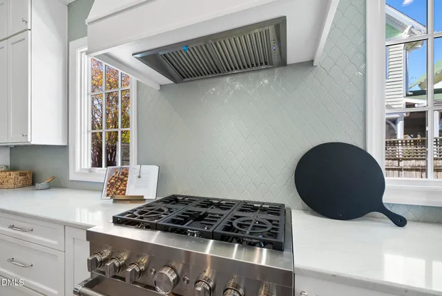 a kitchen with a sink dishwasher and cabinets with wooden floor