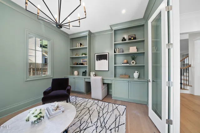 a living room with furniture a table and large window